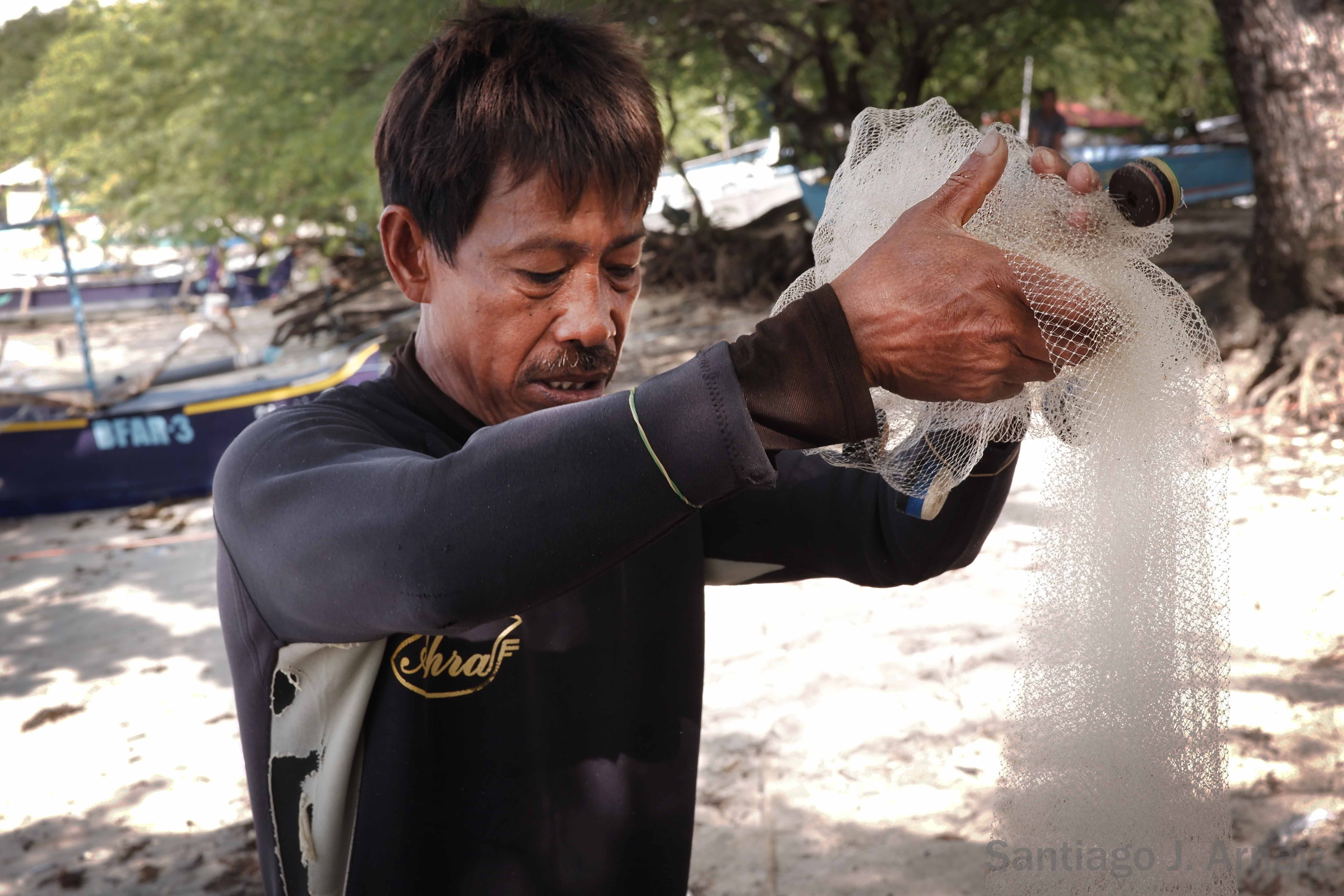 Fisherman tending to his net